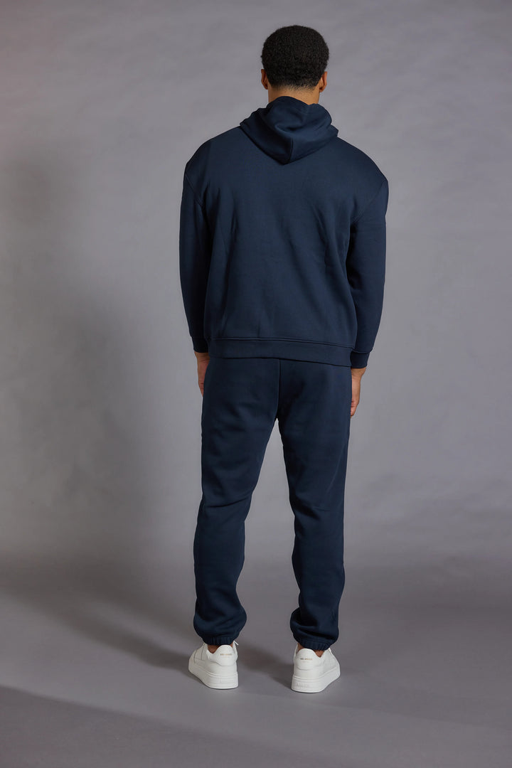 Men Wear a Navy Essentials Hoodie 
