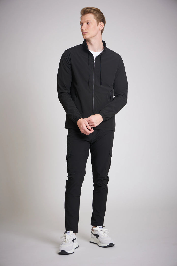 Men's black cargo jacket front zip pockets side view

